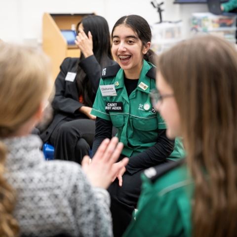 A cadet first aider smiling in a group of young people. A cadet first aider smiling in a group of young people.